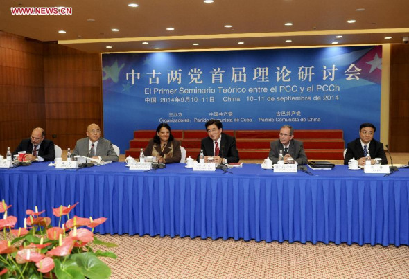 Guo Jinlong (C), a member of the Political Bureau of the Central Committee of the Communist Party of China (CPC) and chief of the CPC Beijing Municipal Committee, addresses the opening of the first theoretical seminar between the Communist Party of China and the Communist Party of Cuba, in Beijing, capital of China, Sept. 10, 2014. (Xinhua/Zhang Duo)