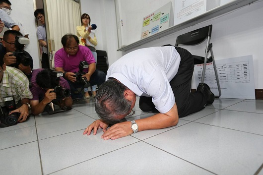 Yeh Wen-hsiang, boss of the Kaohsiung-based Chang Guann Co, the scandalized supplier of gutter oil in Taiwan, keels down at a press conference on September 11, 2014 in Taiwan. [Photo: udn.com]