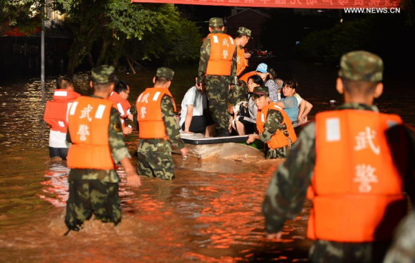 Rescuers try to transfer trapped people in Chongqing, southwest China, Sept. 13, 2014. Downpour is wreaking havoc in southwest China Saturday, leaving at least eight people missing in Chongqing Municipality and causing two deaths in the neighboring Sichuan Province. (Xinhua/Xie Jiang) 
