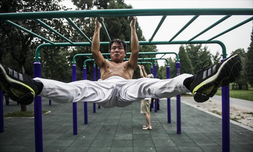 Beijing's elderly gentlemen make the most out of the basic gym equipment that can be found in public parks in almost every neighborhood. Photos: Li Hao/GT