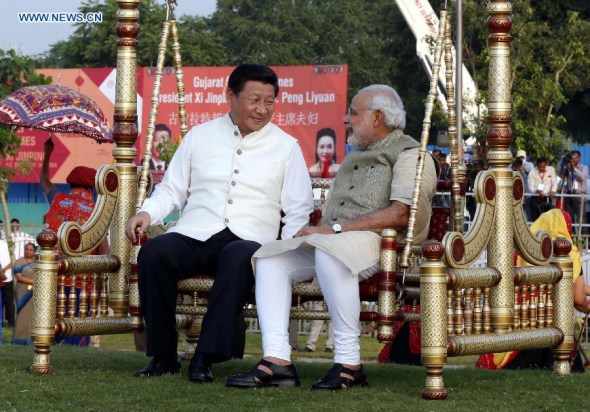 Chinese President Xi Jinping (L) talks with Indian Prime Minister Narendra Modi as they visit a riverside park development project in Gujarat, India, Sept 17, 2014. Xi Jinping visited the state of Gujarat on Wednesday. (Xinhua/Ju Peng)