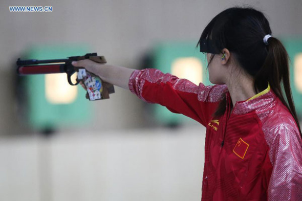 Zhou Qingyuan of China competes during the women's 10m Air Pistol team finals of shooting event at the 17th Asian Games in Incheon, South Korea, Sept 20, 2014. China won the gold medal. This is the first gold medal of the Incheon Asiad. [Photo/Xinhua]