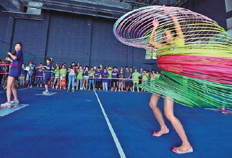 People practice with hula hoops in a gym in Beijing. Pang Zhengzheng / Xinhua  