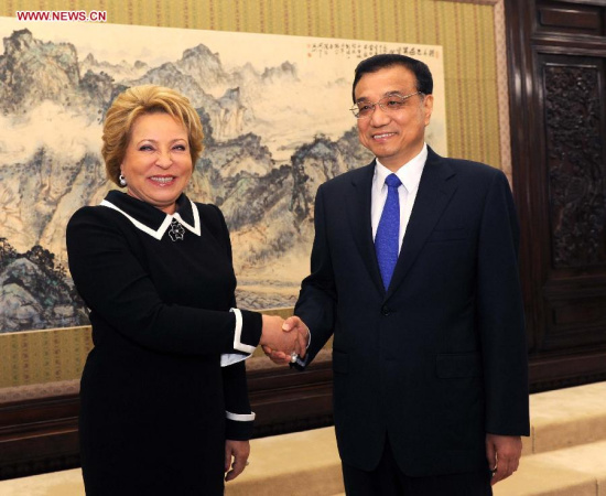 Chinese Premier Li Keqiang (R) shakes hands with Valentina Matviyenko, chairperson of Russia's Federal Assembly, during their meeting in Beijing, capital of China, Sept. 23, 2014. (Xinhua/Rao Aimin)