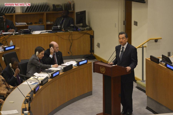 Chinese Foreign Minister Wang Yi (R) addresses a High-Level Event on Ebola during the 69th session of the United Nations General Assembly at the UN headquarters in New York, on Sept 25, 2014. (Xinhua/Yin Bogu)