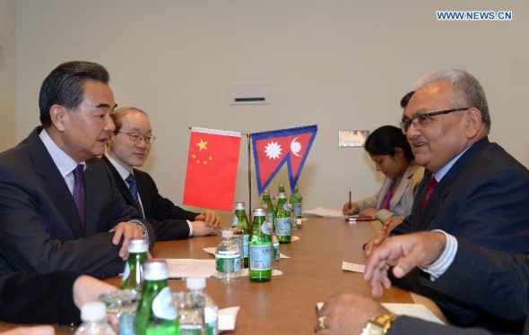 Chinese Foreign Minister Wang Yi (1st L) meets with Nepalese Foreign Minister Mahendra Bahadur Pandey (1st R) at the UN headquarters in New York, on Sept 27, 2014. (Xinhua/Yin Bogu)