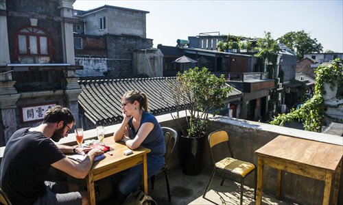 Customers enjoying the afternoon sunshine on the terrace of one of Dashilar's recently refurbished cafes. Photo:Li Hao/GT