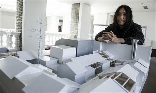 Cao Pu, a Beijing architect, with a model of his planned courtyard hostel. Photo: Li Hao/GT