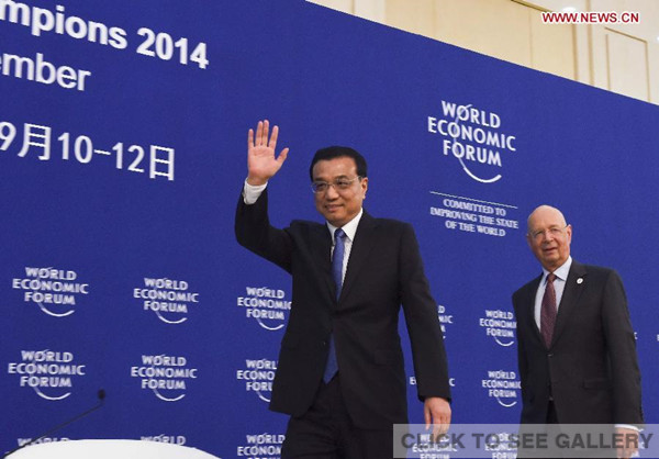Chinese Premier Li Keqiang (L) and Klaus Schwab, founder and executive chairman of the World Economic Forum (WEF), walk into the conference hall of a meeting ahead of the Summer Davos forum in Tianjing Municipality, north China, Sept 9, 2014. (Xinhua/Li Xueren) 