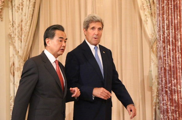 Chinese Foreign Minister Wang Yi (left) and US Secretary of State John Kerry walk towards the podium in the Ben Franklin Room of the State Department in Washington on Wednesday before they address the press ahead of their bilateral meeting. [Photo by Chen Weihua/China Daily]