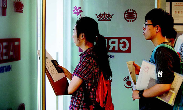 Applicants for visas wait in line at the British visa center in Beijing on Monday. [WANG JING / CHINA DAILY]
