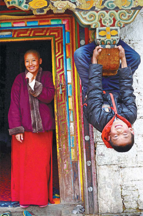 Tashi Phuntsog, 13, poses in front of the camera together with his teacher.