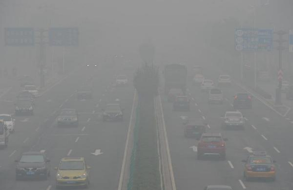 Motorcars run amid smog in Shijiazhuang, capital of north China's Hebei province, Oct 9, 2014. Hebei issued an orange alert for smog on Thursday.(Xinhua/Zhu Xudong)
