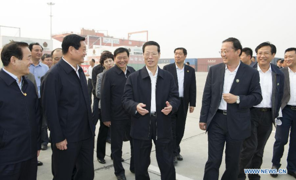 Chinese Vice Premier Zhang Gaoli (C, front) visits the railway container center at the International Trade and Logistics Park of Xi'an, capital of northwest China's Shaanxi Province, Oct. 9, 2014. Zhang visited Xi'an for a symposium on the development of a Silk Road Economic Belt and a 21st Century Maritime Silk Road on Friday. (Xinhua/Huang Jingwen)