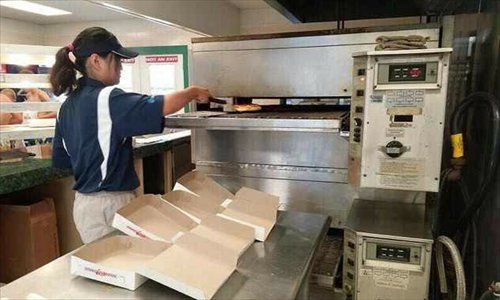 Yang Xue at work in a restaurant in Hamilton Photo: Courtesy of Yang Xue