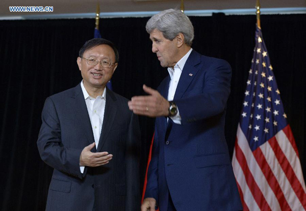 Chinese State Councillor Yang Jiechi (L) and US Secretary of State John Kerry speak to reporters prior to a meeting in Boston, Massachusetts, the United States, Oct. 18, 2014. (Xinhua/Yin Bogu)