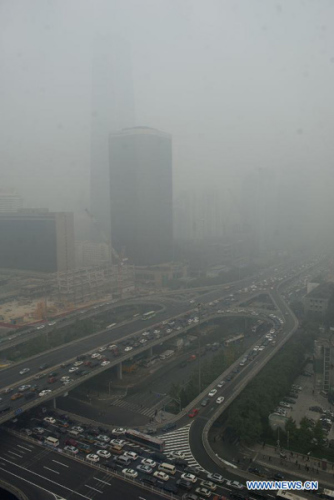 Buildings are shrouded in smog in Beijing, capital of China, Oct. 20, 2014. (Xinhua/Luo Xiaoguang)