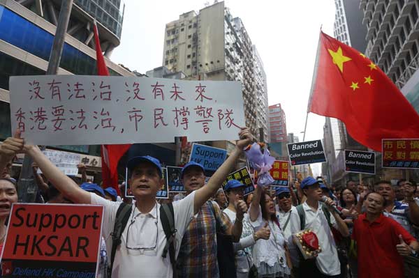 Placards support the police and government at a rally opposing the Occupy Central movement in Hong Kong's Mong Kok district on Wednesday. One placard reads: No rule of law, no future. Hong Kong needs rule of law, and residents support police.