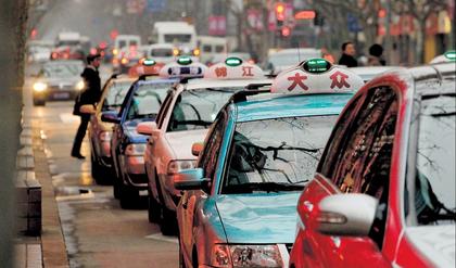 A fleet of taxis on downtown Huaihai Road.  Zhang Dong