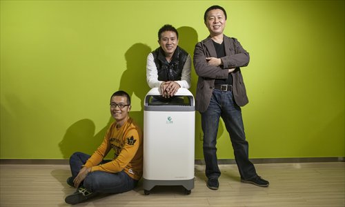 Dai Saiying (middle) and the two other co-founders of Three Papa with the air purifier they developed. Photo: Li Hao/GT