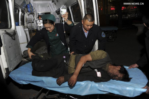 An injured miner is transferred to hospital after a coal mine collapsed in Tiechanggou Township of Urumqi, capital of northwest China's Xinjiang Uygur Autonomous Region, Oct. 25, 2014. Sixteen people were killed and 11 others injured in the accident which happened late Friday night. (Xinhua/Zhao Ge)