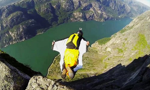Xu Kai, one of the few Chinese wingsuit enthusiasts, flies among the mountains. Photo: Courtesy of Xu Kai