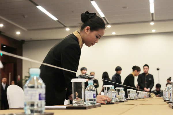 Staff members at the China National Convention Center demonstrate how to set up a meeting room for the upcoming gathering of APEC leaders that will take place in Beijing next week. The center is a major venue for the gathering. Wang Jing / China Daily