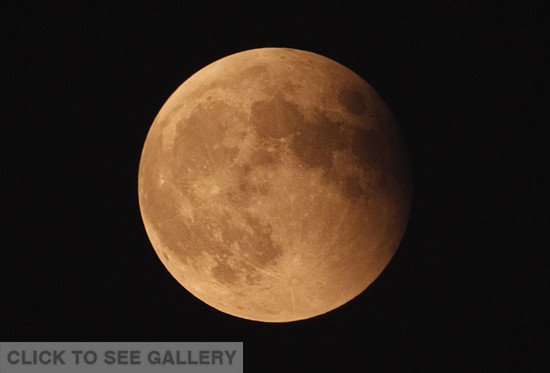 The moon is seen in the sky during a total lunar eclipse in Haikou, capital of south China's Hainan province, Oct 8, 2014. A total lunar eclipse is sometimes called a blood moon because of the red color that is cast upon it by light refracting in Earth's atmosphere. (Xinhua/Zhao Yingquan) 