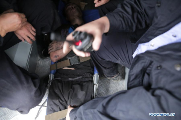 Li Mengjun (C), an inmate who escaped from Beijiang Prison on Saturday, is captured near the prison in Shaoguan City, south China's Guangdong Province, Nov. 2, 2014. Two inmates in Beijiang Prison on Saturday left a workshop through fire engine access, broke the lock of a door when others were working, and climbed over prison walls to escape. Wu Changgui, one of the inmates, was knocked down by electrified wire netting and recaptured, while another one Li Mengjun got out of the prison. (Xinhua/Mao Yizhu)