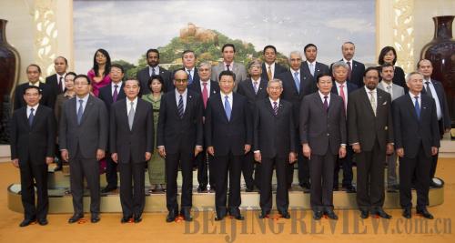 BOOSTING CONNECTIVITY: Chinese President Xi Jinping (front center) poses with representatives of 21 countries that signed the memorandum of understanding on establishing the Asian Infrastructure Investment Bank in Beijing on October 24 (HUANG JINGWEN)