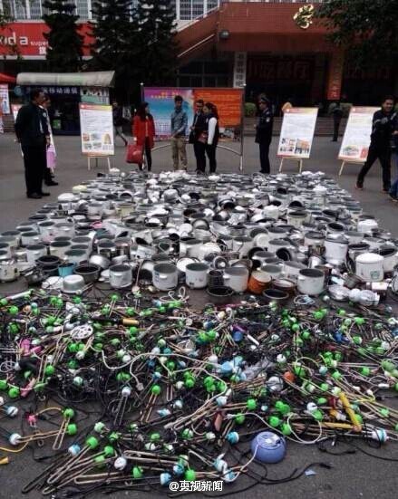 Southwest University for Nationalities makes a public display of confiscated rice cookers and other appliances on its campus in Chengdu, Southwest China's Sichuan province, on Nov 5, 2014. [Photo/Sina Weibo] 