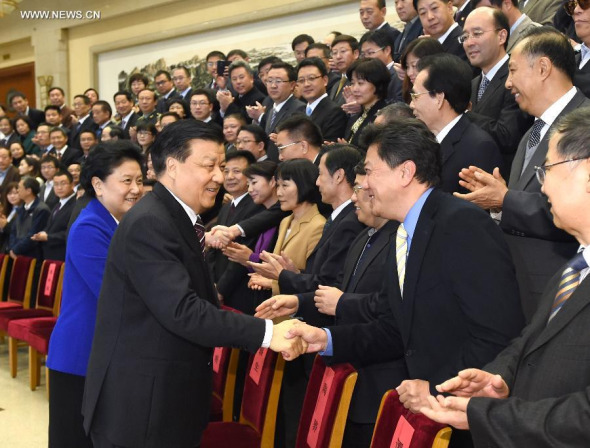 Liu Yunshan, a member of the Standing Committee of the Political Bureau of the CPC Central Committee, shakes hands with prize-winners at the prize-giving ceremony of the 24th China Journalism Awards and the 13th Changjiang Taofen Awards in Beijing, capital of China, Nov. 7, 2014. (Xinhua/Ma Zhancheng)
