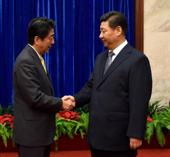 Chinese President Xi Jinping (R) and Japanese Prime Minister Shinzo Abe hold a meeting at the request of the Japanese side ahead of the 22nd Asia-Pacific Economic Cooperation (APEC) Economic Leaders' Meeting in Beijing, China, Nov. 10, 2014. (Xinhua/Ma Zhancheng)