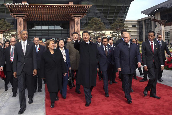 Chinese President Xi Jinping (C Front) and U.S. President Barack Obama, Chilean President Michelle Bachelet, Sultan of Brunei Hassanal Bolkiah, Russian President Vladimir Putin and Indonesian President Joko Widodo (L to R) walk to plant trees with other leaders and representatives from the Asia-Pacific Economic Cooperation (APEC) to mark friendship in the APEC family in Beijing, capital of China, Nov. 11, 2014. (Xinhua/Lan Hongguang)