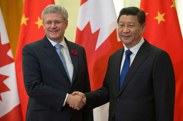 Prime Minister Stephen Harper is greeted by Xi Jinping, President of the People's Republic of China, upon his arrival at the Great Hall of the People during his official visit to China on Nov 9 in Beijing, China. Photo by Jason Ransom  