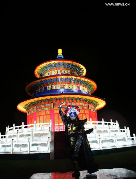 An artist performs face changing at the illumination ceremony for the Chinese Festival of Light in Longleat of Wiltshire, southwest England, on Nov 12, 2014. More than 100 workers from Zigong City of southwest China's Sichuan Province have made 7,000 lanterns, which will be displayed at the Chinese Festival of Light lasting from Nov 14 to next January. (Xinhua/Han Yan)
