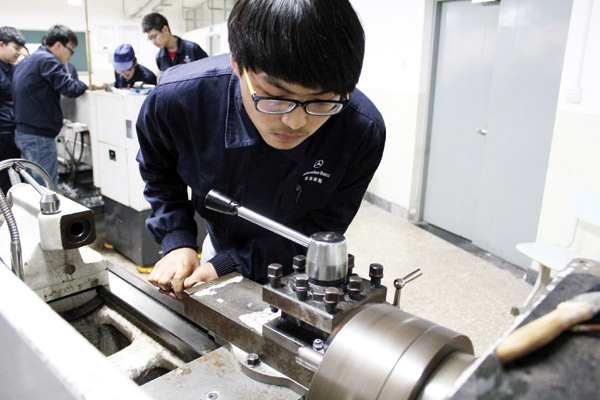 A student is learning basic lathe and turning work at Beijing Polytechnicthe, the biggest vocational school in the Chinese capital. Wang Zhuangfei / For China Daily 