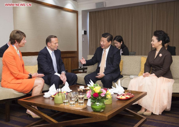 Chinese President Xi Jinping (2nd R) and his wife Peng Liyuan talk with Australian Prime Minister Tony Abbott (2nd L) and his wife Margie Abbott before departing from Sydney, Australia, on Nov. 19, 2014. Xi Jinping concluded his state visit to Australia on Wednesday. (Xinhua/Huang Jingwen)
