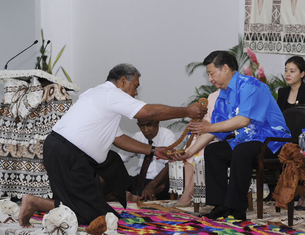 President Xi Jinping receives a whale's tooth during a traditional welcoming ceremony in Nadi, Fiji, on Friday following his visit to New Zealand where the two countries signed 10 agreements covering various fields. RAO AIMIN / XINHUA