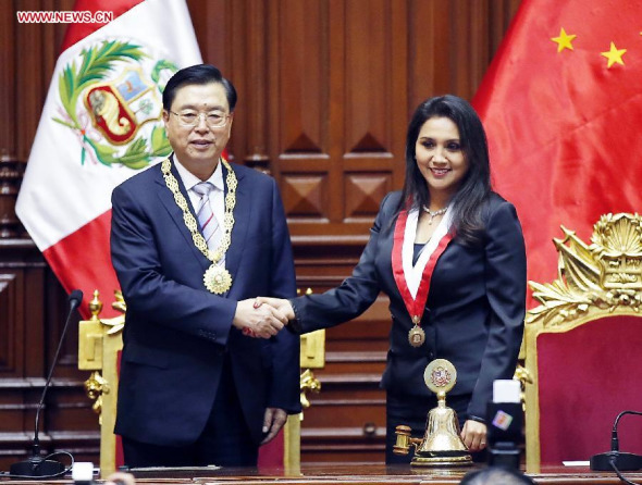 Zhang Dejiang (L), chairman of the Standing Committee of China's National People's Congress (NPC), receives a decoration awarded by President of the Peruvian Congress Ana Maria Solorzano on behalf of the Peruvian Congress after they held talks in Lima, Peru, on Nov. 21, 2014. Zhang Dejiang is in Peru for an official goodwill visit. (Xinhua/Liu Jiansheng)
