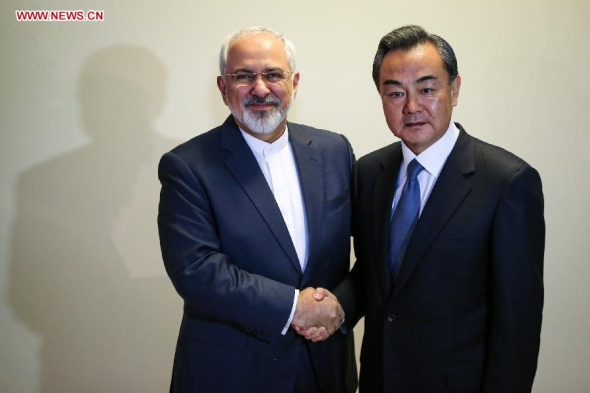Chinese Foreign Minister Wang Yi (R) shakes hands with his Iranian counterpart Mohammad Javad Zarif at Palais Coburg, the venue of nuclear talks in Vienna, Austria, Nov. 24, 2014. The parties involved in Iran's nuclear talks may consider extension of the negotiation if time is not enough for a deal, Chinese Foreign Minister Wang Yi said here on Monday. (Xinhua/Zhang Fan) 