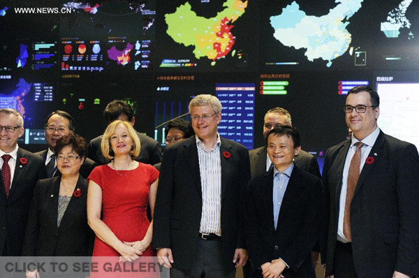 Canadian Prime Minister Stephen Harper (3rd R, front) and Executive Chairman of Alibaba Group Jack Ma (2nd R, front) pose for photos in Hangzhou, capital of east China's Zhejiang Province, Nov. 7, 2014. Stephen Harper on Friday visited Alibaba Group, a Chinese e-commerce company based in Hangzhou. Harper arrived Thursday in Hangzhou to start an official visit to China at the invitation of Chinese Premier Li Keqiang. (Xinhua/Ju Huanzong)