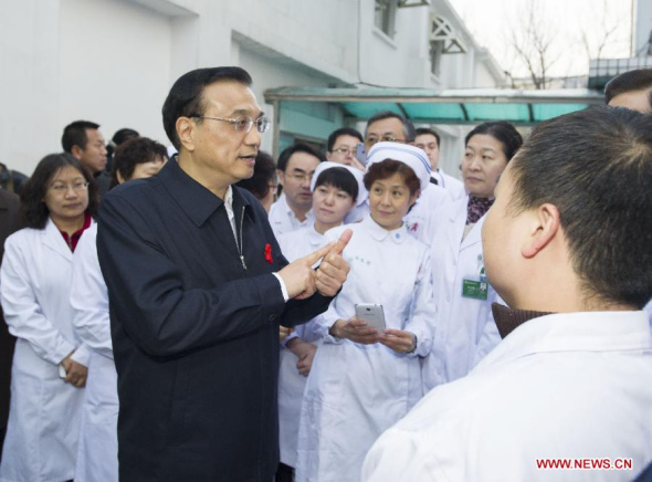 Chinese Premier Li Keqiang visits medical workers at Beijing's YouAn Hospital, home to a center for HIV/AIDS treatment, in Beijing, capital of China, ahead of World AIDS Day. (Xinhua/Xie Huanchi)