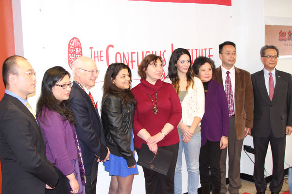 Members of the Pace University Confucius Institute and the New York Chinese Opera Society (NYCOS) award two students with cash prizes on Monday at Pace University in New York for their submissions to the Fourth Annual NYCOS Essay Competition. Julieth Saenz (fourth from left) and Elizabeth Delaney (fourth from right), both seniors at Pace University, took home the first- and third-place prizes, respectively. Jack Freifelder/ China Daily.