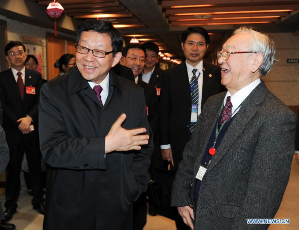 Chen Deming (L front), president of the mainland-based Association for Relations Across the Taiwan Strait (ARATS), talks with an elder during his visit to Chang Gung Culture Village in Taipei, southeast China's Taiwan, Dec. 9, 2014. Chen arrived in Taiwan on Tuesday noon to start a 8-day visit to the island. (Xinhua/Shen Hong)