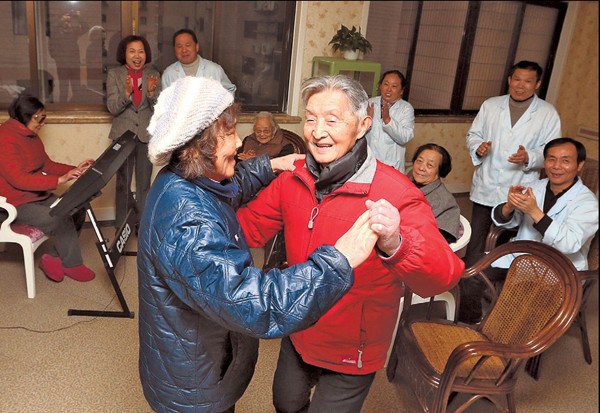 Residents dance at the Liyang Road care home, where prices start at 4,800 yuan a month. [Xinhua]