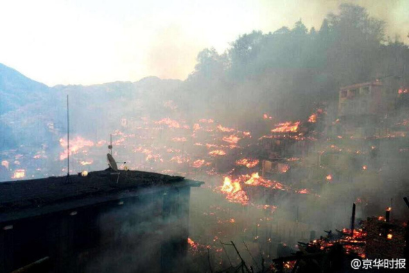 A fire engulfs an ethnic village in southwest China's Guizhou province Friday afternoon, with more than 60 houses destroyed. (Photo: Sina Weibo of Beijing News) 