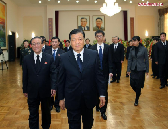 Liu Yunshan (front), a member of the Standing Committee of the Political Bureau of the Communist Party of China (CPC) Central Committee, attends a ceremony at the Democratic People's Republic of Korea (DPRK) embassy in China on the third anniversary of the demise of Kim Jong Il, former supreme leader of DPRK, in Beijing, capital of China, Dec. 17, 2014. (Xinhua/Liu Weibing)