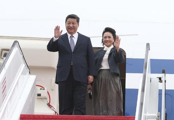 Chinese President Xi Jinping (L) and his wife Peng Liyuan wave as they arrive at the international airport in Macao, south China, Dec. 19, 2014. Chinese President Xi Jinping arrived here Friday noon to attend celebrations marking the 15th anniversary of Macao's return to the motherland, which falls on Saturday. (Xinhua/Lan Hongguang)