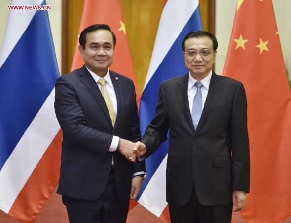 Chinese Premier Li Keqiang (R) shakes hands with visiting Thai Prime Minister Prayuth Chan-ocha before their talks in Beijing, capital of China, Dec 22, 2014. (Xinhua/Xie Huanchi)  